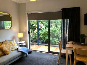 a living room with a couch and a sliding glass door at a'meadow in Trentham