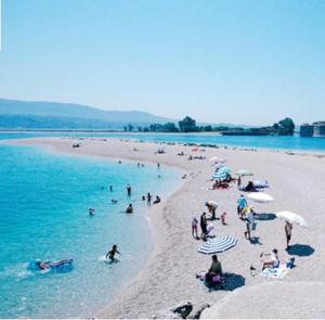 a group of people on a beach in the water at Seaview Kaposantes Apartments in Lefkada