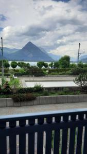 a blue fence with a view of a body of water at Lakeside Interlaken Jungfrau in Därligen
