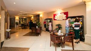 a group of people standing in a hotel lobby at White Lion Hotel in Ho Chi Minh City