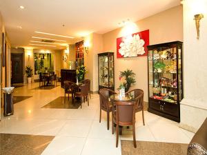 a restaurant with tables and chairs in a room at White Lion Hotel in Ho Chi Minh City
