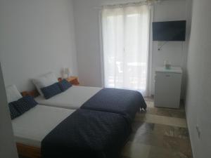 a bedroom with a large bed and a window at Demos Studios in Kandia
