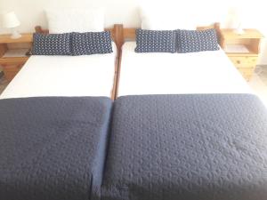 two beds sitting next to each other in a bedroom at Demos Studios in Kandia