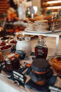a table topped with food and a bottle of syrup at Hotel Riva by Aycon in Petrovac na Moru