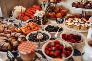a table filled with different types of desserts and pastries at Hotel Riva by Aycon in Petrovac na Moru