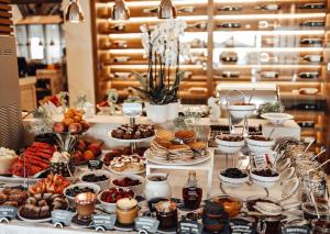a buffet with desserts and other food on a table at Hotel Riva by Aycon in Petrovac na Moru