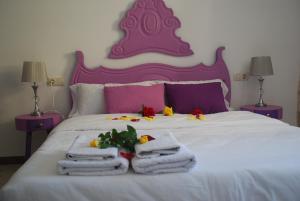 Un dormitorio con una cama blanca con toallas. en Cal Sabater en Preixana