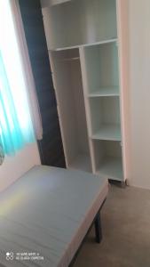 a bedroom with a bed and an empty closet at Mobil-home L'Olivier in Fréjus