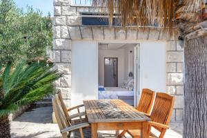 a wooden table and chairs on a patio at Hostel Villa Skansi in Hvar