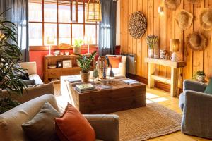 a living room with couches and a coffee table at Hotel de La Plage in Contis-les-Bains