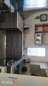 a kitchen with a sink and a clock on the wall at Mobil-home L'Olivier in Fréjus