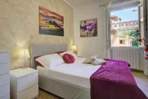 a bedroom with a large bed and a window at Fortezza Central Apartment in Florence