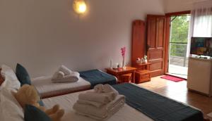 a bedroom with two beds with towels on them at Casa Carina in Jupiter