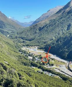 an aerial view of a valley with a river and mountains at Arthur's Pass Motel & Lodge in Arthur's Pass