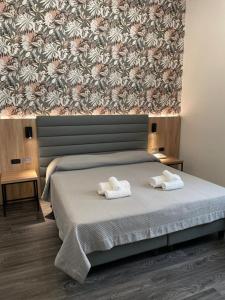 Postel nebo postele na pokoji v ubytování Hotel Delle Camelie
