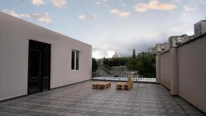 een patio met twee banken aan de zijkant van een gebouw bij Babilon Hotel Tbilisi in Tbilisi City