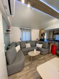 a living room with a couch and a table at Mobil home de charme in Fréjus