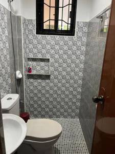 a bathroom with a toilet and a sink at JG Privspace in San Juan