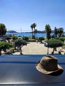 a straw hat sitting on the ledge of a window at Seaview-Apartments in Palaia Fokaia