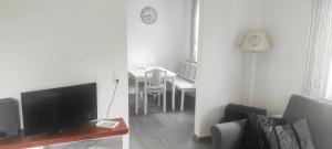 a living room with a television and a dining room table at Ferienwohnung Klötsch in Katzwinkel