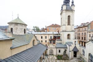 a view of a city with a church and a tower at Просторі апартаменти в центрі Львова in Lviv