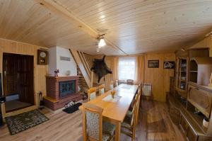 a dining room with a table and a fireplace at Agroturystyka Nad Tanwią in Biszcza