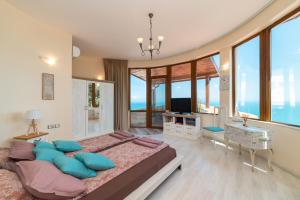 a bedroom with a large bed with blue pillows at Sunny House Izgrev in Balchik