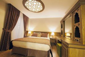 a hotel room with a bed and a mirror at Hotel Ney in Konya