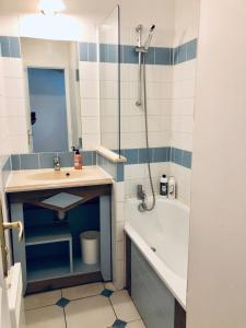 a bathroom with a sink and a shower and a tub at Bel appartement cosy en résidence avec piscine in Deauville