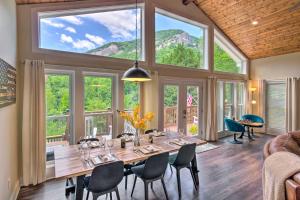 comedor con mesa, sillas y ventanas grandes en Unique Chimney Rock Home with Breathtaking View, en Lake Lure