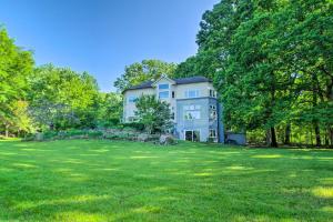 a large house in the middle of a grassy field at Renovated Studio on 5 Acres - Near Vineyards! in Crozet