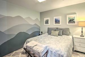 a bedroom with a bed with a mountain mural on the wall at Renovated Studio on 5 Acres - Near Vineyards! in Crozet