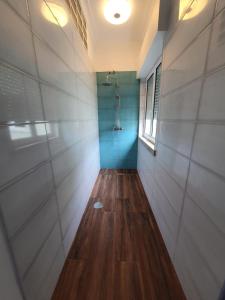a hallway with a shower with a blue wall at Castilho 63 Hostel & Suites in Lisbon
