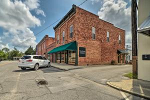 a white car parked in front of a brick building at Charming DeFuniak Apartment in Historic Dtwn! in DeFuniak Springs