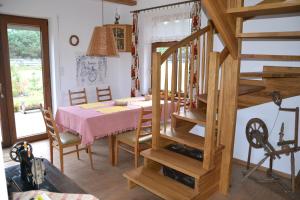 a dining room with a table and a staircase at Zagajnik Holiday House in Sucha Rzeczka +32 photos