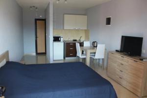 a bedroom with a bed and a kitchen with a table at Villa Malina Luštica in Tivat