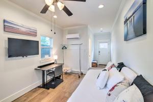 a living room with a white couch and a flat screen tv at Cozy Houston Studio Pet Friendly and Free WiFi in Houston