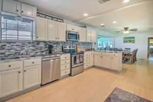 a large kitchen with white cabinets and a dining room at Waterfront Onalaska Retreat with Private Dock! in Blanchard