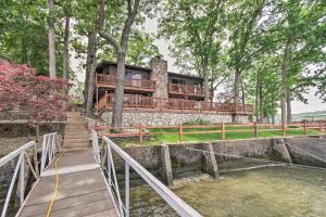 an image of a house with a staircase leading up to it at Waterfront Lake Ozark Home with Private Dock! in Lake Ozark