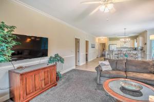 a living room with a couch and a table at Sunny Myrtlewood Condo with Golf and Pool Near Beach! in Myrtle Beach