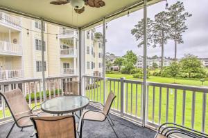 a balcony with a glass table and chairs at Sunny Myrtlewood Condo with Golf and Pool Near Beach! in Myrtle Beach