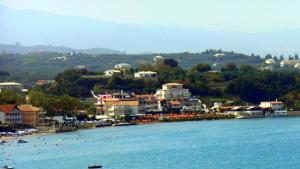 a large body of water with houses at Corali Beach in Tsilivi