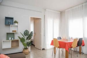 a dining room with a red table and chairs at Sunny and Quiet Sagrada Familia in Barcelona