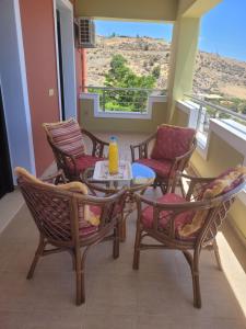 a balcony with a table and chairs with a view at Villa Thea in Kaloi Limenes