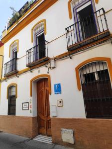 a large building with a clock on the side of it at Hostel Triana Backpackers in Seville