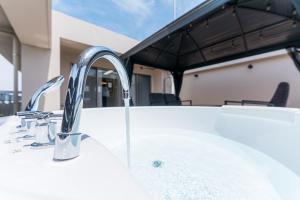 a sink with two faucets on a bath tub at Oshiage Sky View Terrace Penthouse - brand new Hot Tab installed July 2025- in Tokyo