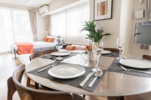 a dining room with a table and chairs and a living room at Oshiage Sky View Terrace Penthouse - brand new Hot Tab installed July 2025- in Tokyo