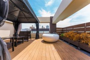 a bathroom with a bath tub on a deck at Oshiage Sky View Terrace Penthouse - brand new Hot Tab installed July 2025- in Tokyo +57 photos
