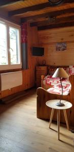 a bedroom with a bed and a table in a room at Le Chalet de Goncelin in Goncelin