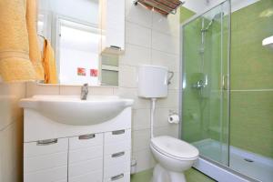 a bathroom with a toilet and a sink and a shower at Apartments Dida in Hvar +14 photos